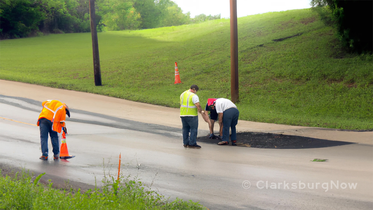 A construction crew repairs a pothole